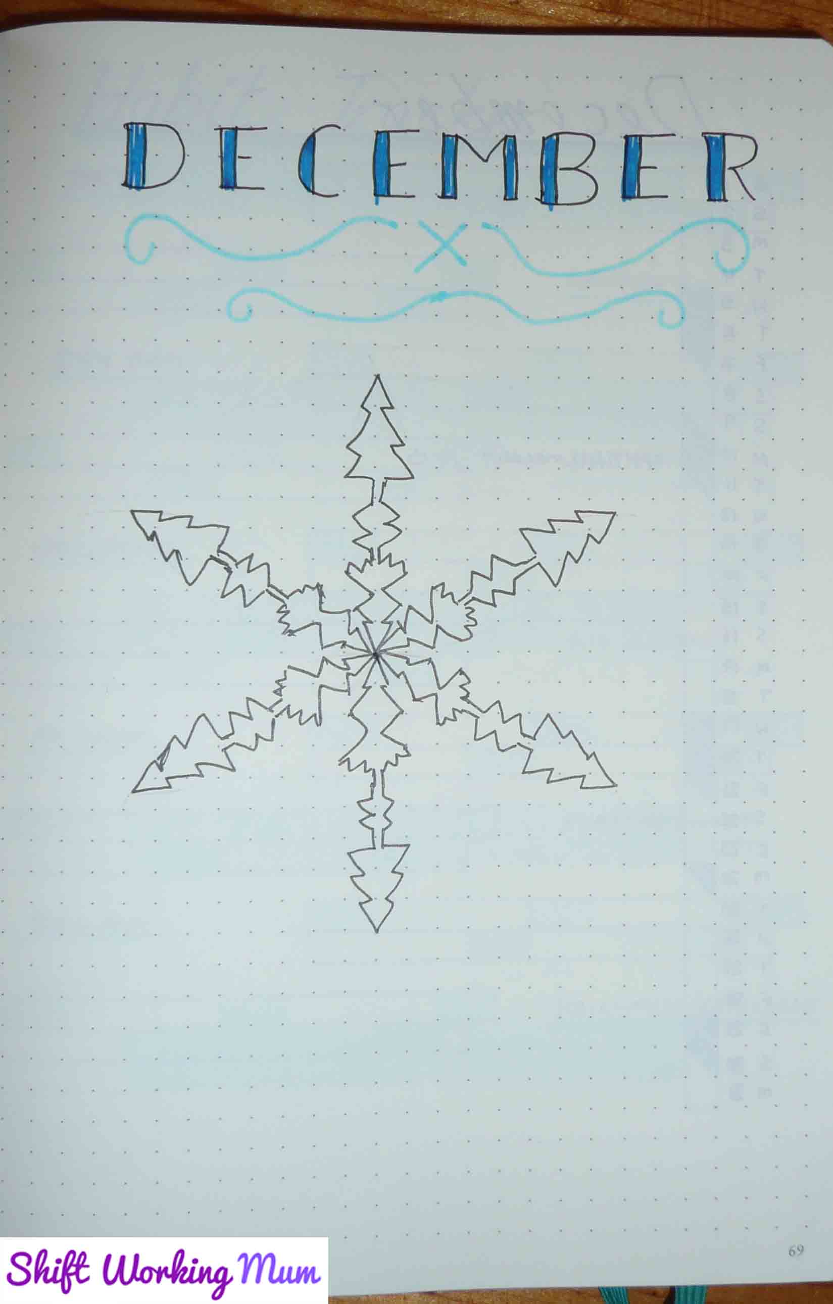 December cover page, December in block print and a drawing of a snowflake